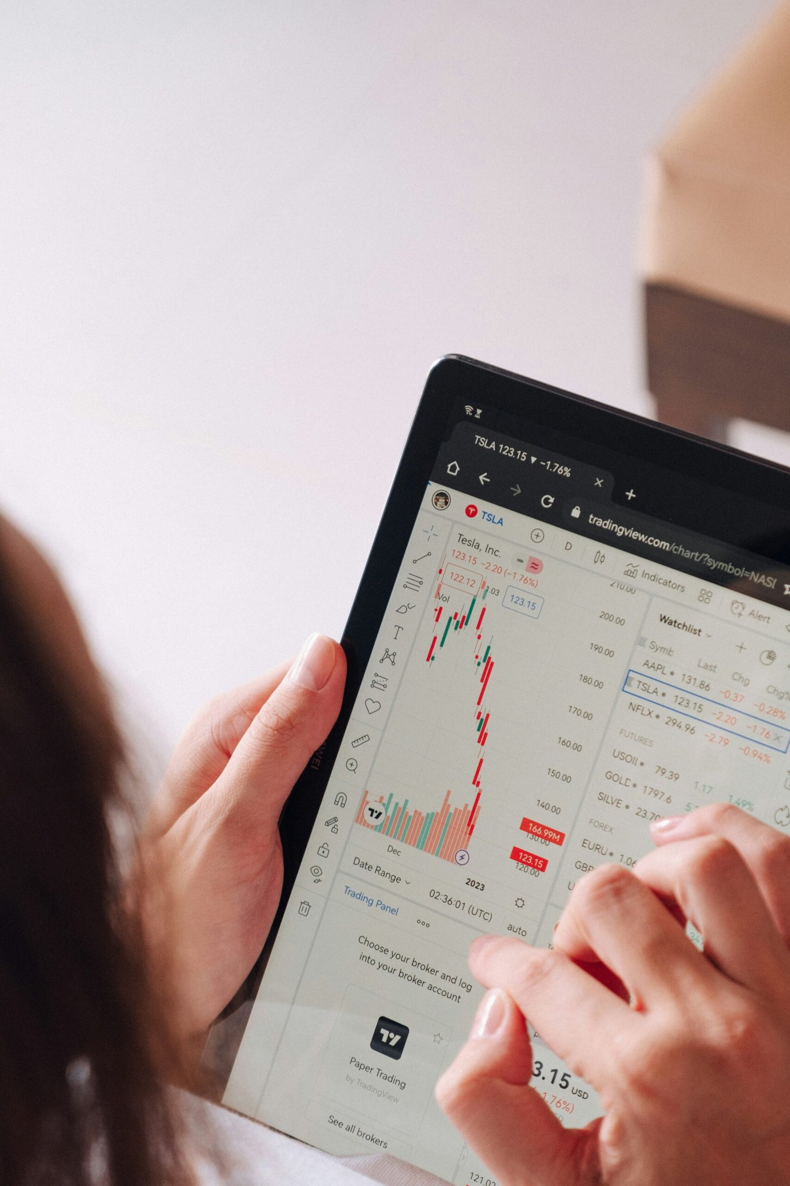 a woman holding a tablet with a chart on it