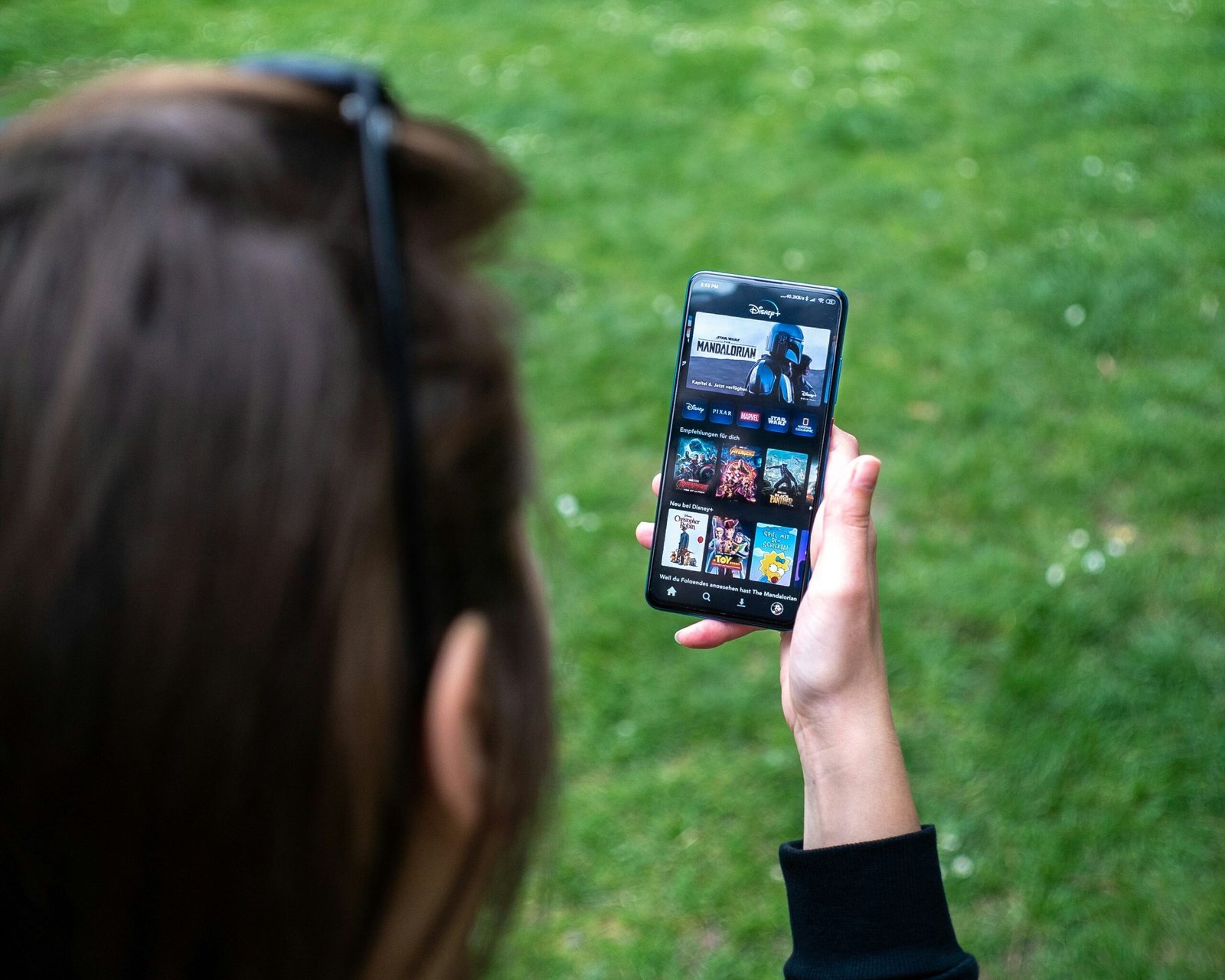 woman holding black android smartphone